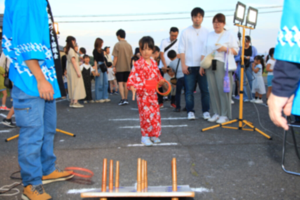 ほたる祭り2025で輪投げをする子どもと見守る保護者
